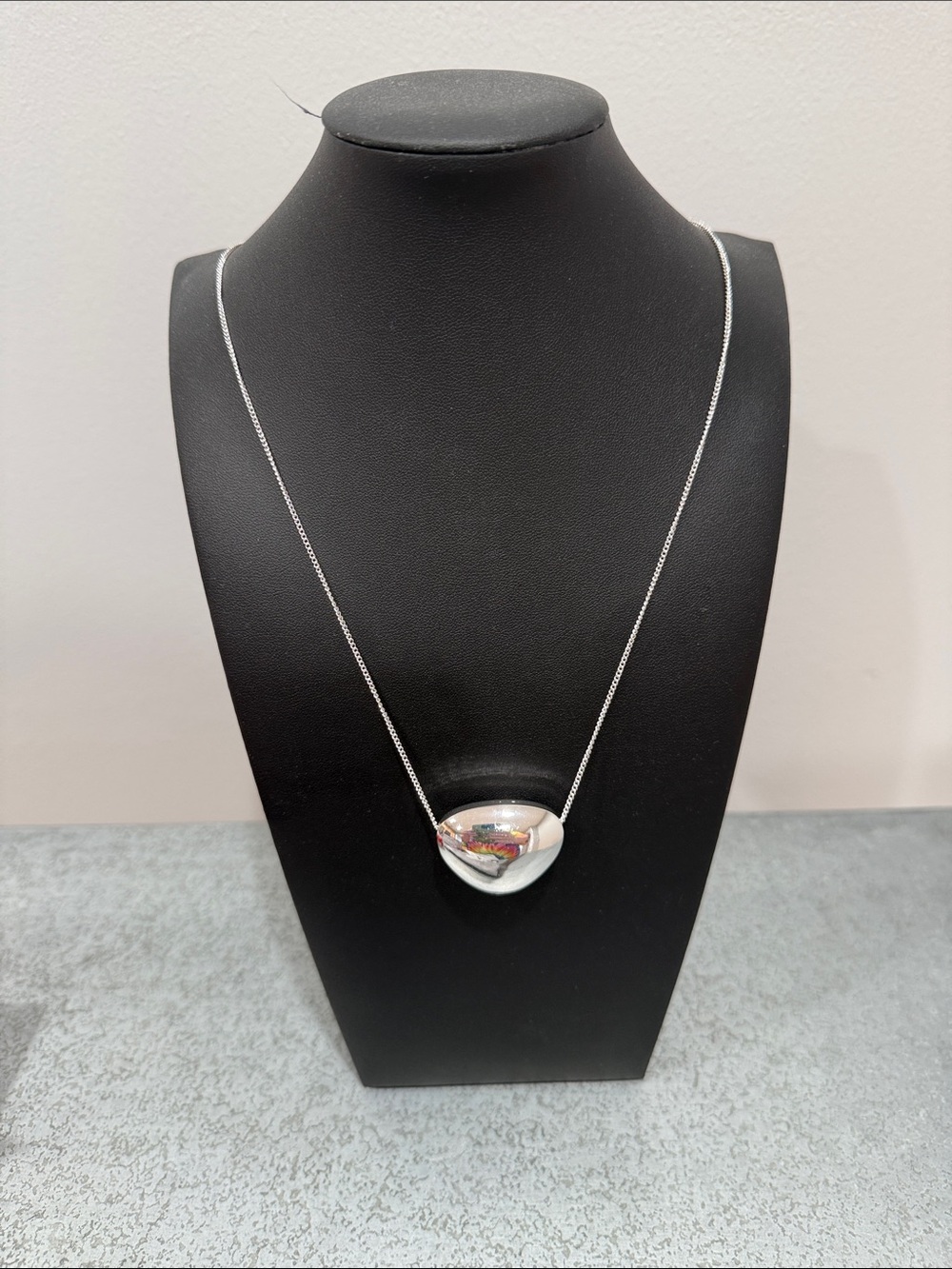 Black Necklace Display with Silver Long Pendant Necklace - Women's Jewelry.